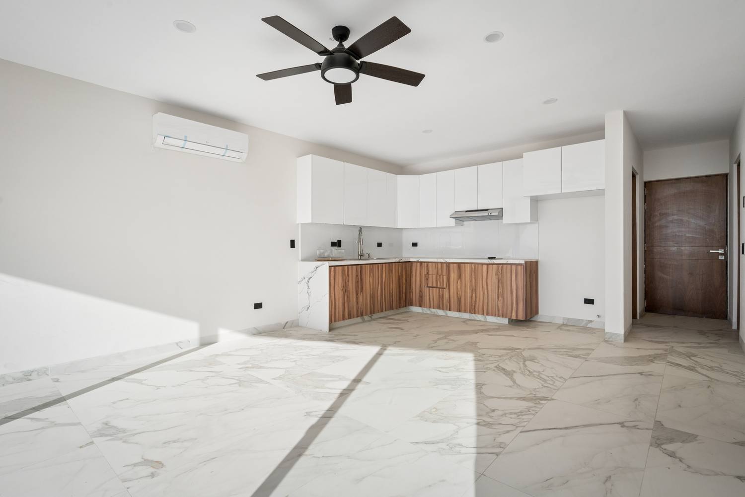 Cocina abierta y sala con piso tipo mármol y abanico de techo